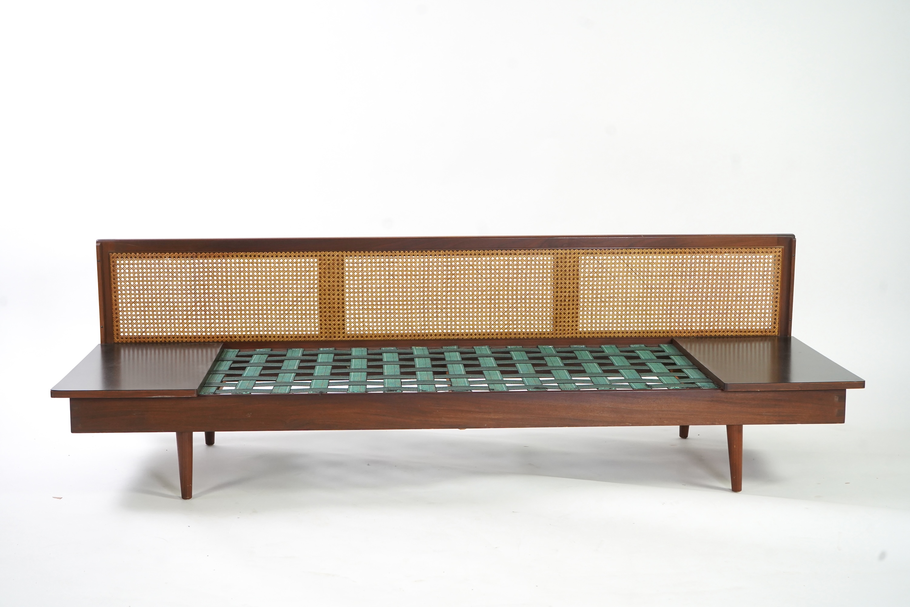 Dennis Young (British): A caned teak sofa/daybed